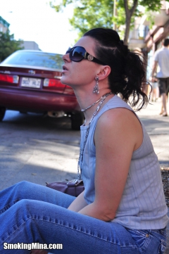 Brunette babe smoking while loitering on the street - N