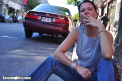 Brunette babe smoking while loitering on the street - N