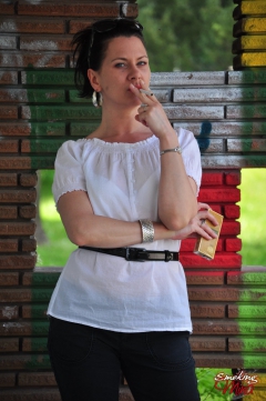 Brunette babe smoking against the wall - N