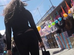 Foxy ebony is walking around at a fair showing her thong to