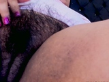 Closeup of hairy pussy with vibrator on webcam.