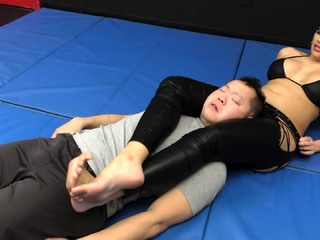 She wrestle him down on the mat and jerks off his cock